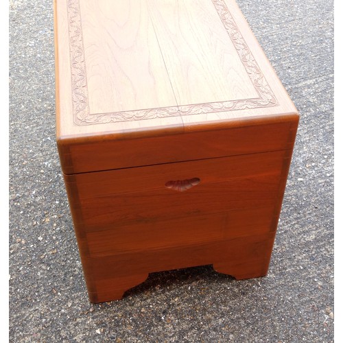 328 - Oriental teak chest with carved bands, hinged top and camphorwood lined interior with sliding tray, ... 