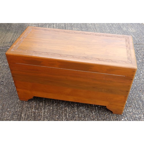 328 - Oriental teak chest with carved bands, hinged top and camphorwood lined interior with sliding tray, ... 