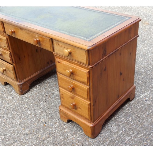 333 - Victorian style pine pedestal desk with a gilt tooled leather top and 9 drawers, on bracket feet, W.... 