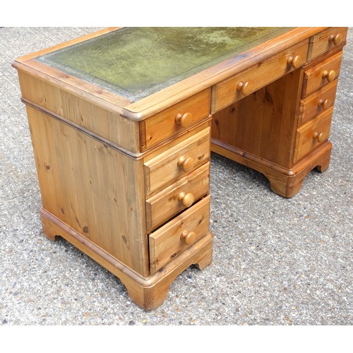 333 - Victorian style pine pedestal desk with a gilt tooled leather top and 9 drawers, on bracket feet, W.... 