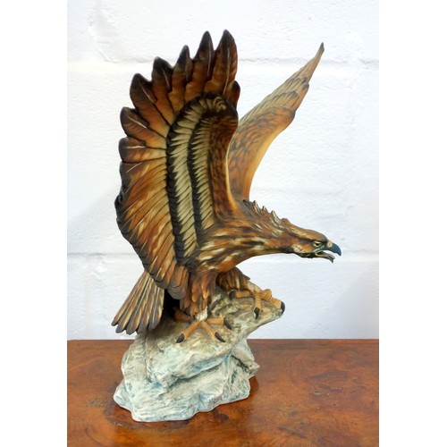 196 - Capodimonte model of an eagle with wings outstretched, perched on a craggy rock, signed V. Binoli, H... 