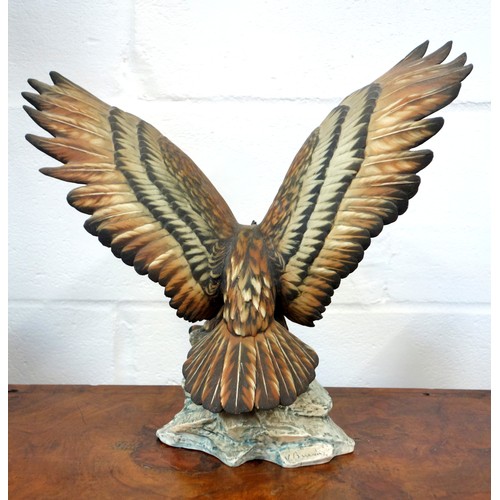 196 - Capodimonte model of an eagle with wings outstretched, perched on a craggy rock, signed V. Binoli, H... 