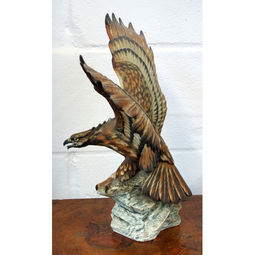 196 - Capodimonte model of an eagle with wings outstretched, perched on a craggy rock, signed V. Binoli, H... 