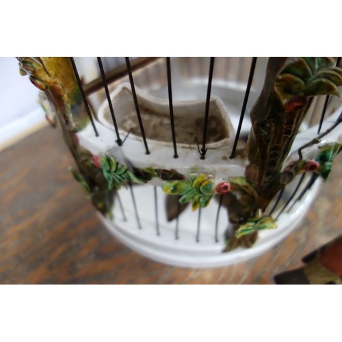 164 - Italian ceramic cylindrical birdcage with all-over encrusted floral decoration, door a/f, with two t... 