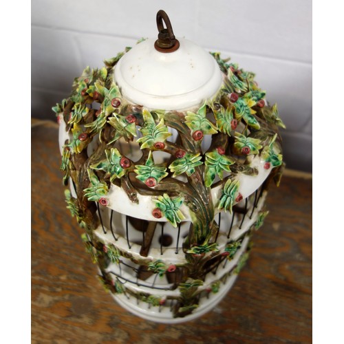 164 - Italian ceramic cylindrical birdcage with all-over encrusted floral decoration, door a/f, with two t... 