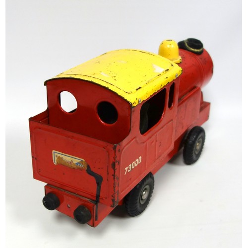 218 - Triang red and yellow tinplate model of a locomotive, the front wheels turning to pump bellows in ca... 