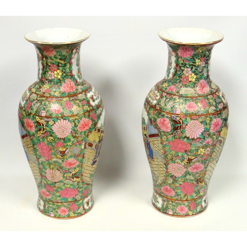 216 - Pair of 20th century Chinese Canton baluster vases, each painted with 2 reserves of figures in a gar... 