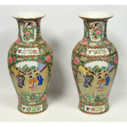 216 - Pair of 20th century Chinese Canton baluster vases, each painted with 2 reserves of figures in a gar... 