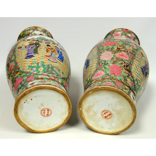 216 - Pair of 20th century Chinese Canton baluster vases, each painted with 2 reserves of figures in a gar... 