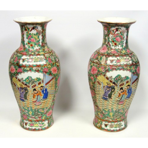 216 - Pair of 20th century Chinese Canton baluster vases, each painted with 2 reserves of figures in a gar... 