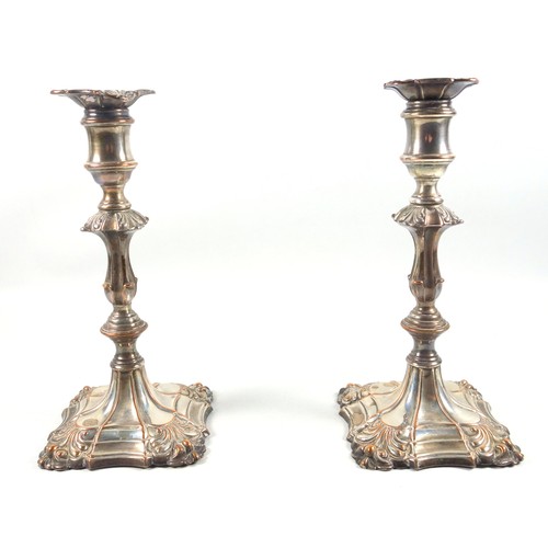 22 - Pair of mid 18th century Old Sheffield plated candlesticks, each with embossed floral decoration, ba... 