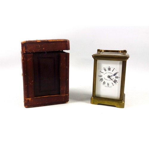 34 - An early 20th century brass carriage timepiece with white Roman numeric dial, marked 