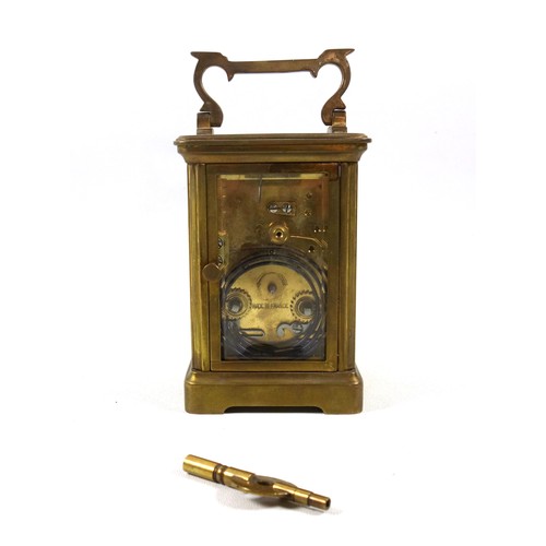 34 - An early 20th century brass carriage timepiece with white Roman numeric dial, marked 