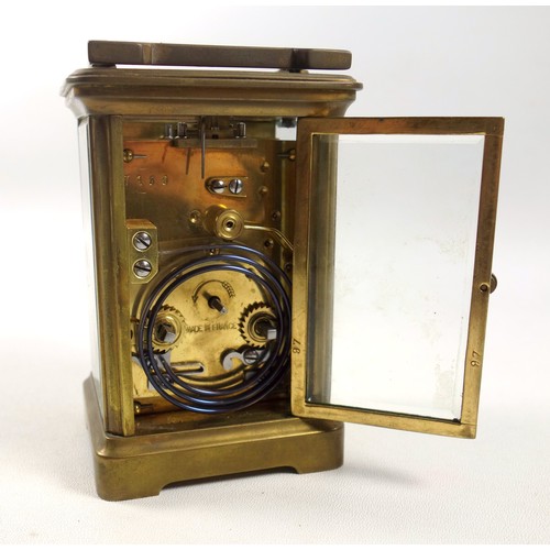 34 - An early 20th century brass carriage timepiece with white Roman numeric dial, marked 