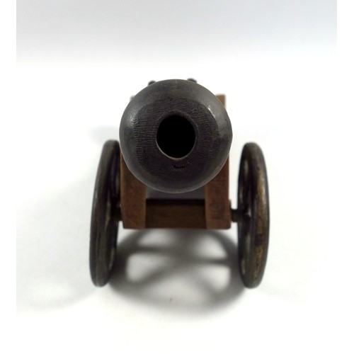 64 - A bronze model of a Dutch East India cannon, possibly a signal cannon, mounted on a wooden carriage,... 