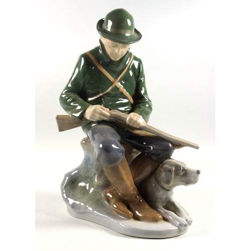 127 - Royal Copenhagen figure of a hunter and his dog, No. 1087, H.22cm