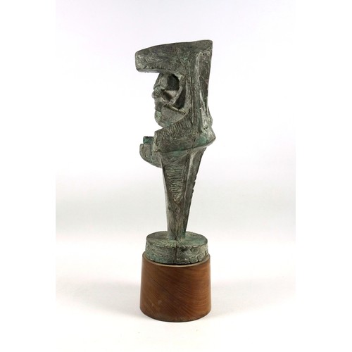 26 - Bronzed resin abstract sculpture as a giant nail of a miner kneeling in a rock crevice, on a teak ci... 