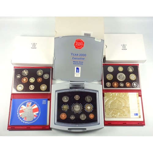 569 - Elizabeth II de luxe Proof sets of coins, 1999-2004, including the 2000 Millennium Executive set, in... 