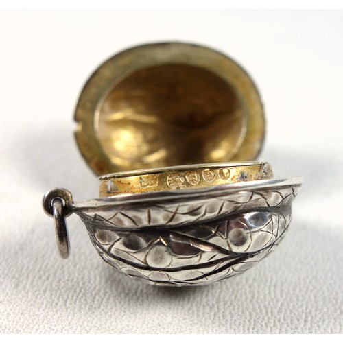 42 - Late Victorian silver vinaigrette in the form of a walnut, the hinged cover, rising to disclose a gi... 