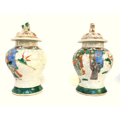 124 - Pair of Chinese famille verte baluster vases, each with a cover surmounted by a dog, decorated with ... 