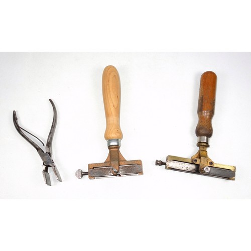 63 - 2 type holders, opening W.10cm and 7.5cm; and a pair of band nippers. (3)