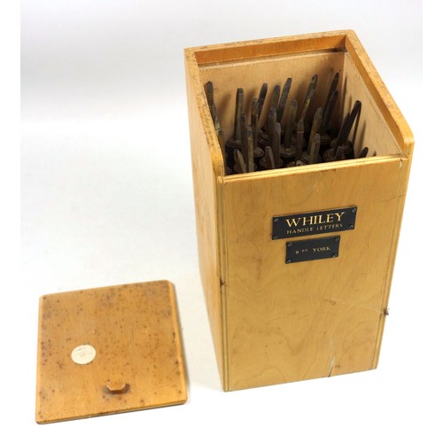 109 - Wooden box containing 36 gold finishing hand tools comprising incomplete alphabet, (missing C and L)... 