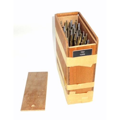 110 - Wooden box containing 40 gold finishing hand tools comprising complete alphabet, numbers 0-9, ampers... 