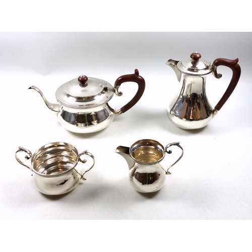 9 - George V silver 4 piece tea set with circular teapot with hinged domed cover, bakelite finial and lo... 