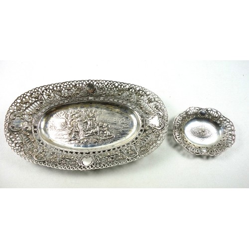 11 - German silver oval dish with a central chased and embossed reserve of 4 cherubs under a tree with ca... 