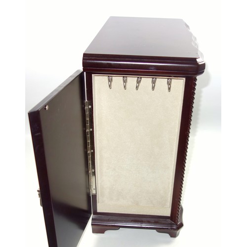 72 - A mahogany finish jewellery cabinet containing a quantity of earrings, brooches, necklaces, watches ... 