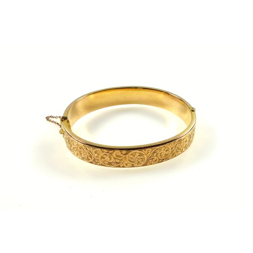 90 - 9ct gold bracelet, half decorated with a scrolling foliate design, internal width 6cm, 13.4 grams.