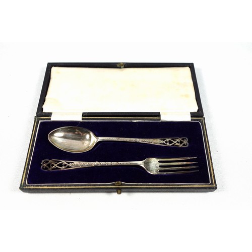 69 - George V silver 2 piece christening set comprising fork and spoon, each with a pieced handle, by A M... 