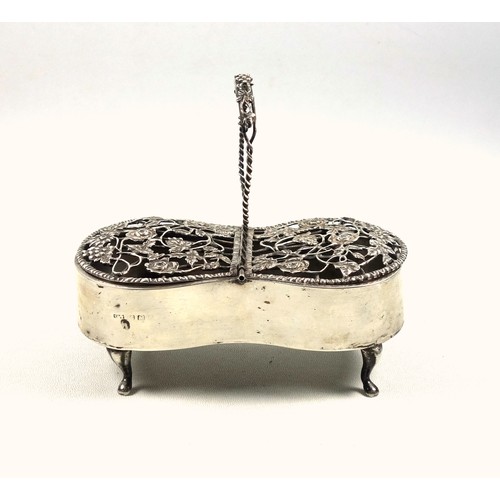 93 - Silver pot pourri box with a floral pierced double hinged cover, with monogram, swing handle, on 4 c... 