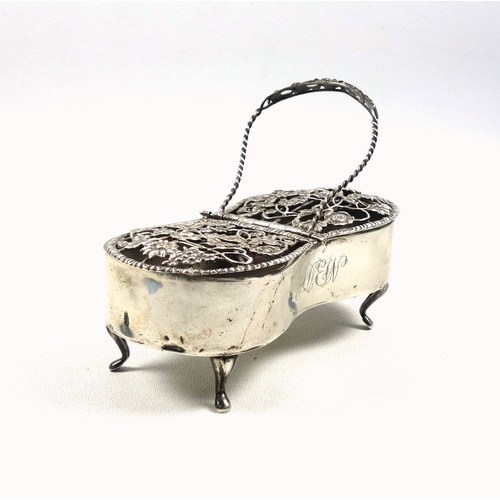 93 - Silver pot pourri box with a floral pierced double hinged cover, with monogram, swing handle, on 4 c... 