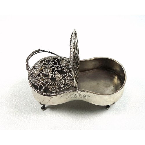 93 - Silver pot pourri box with a floral pierced double hinged cover, with monogram, swing handle, on 4 c... 