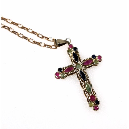 123 - 9ct gold filigree double-sided cross studded with a variety of shaped rubies, blue and green sapphir... 