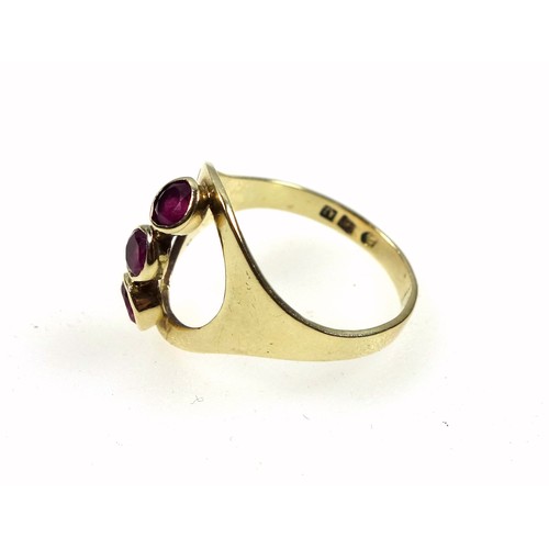 139 - Yellow metal ring set three 'floating' rubies, size K1/2, tested 14ct, 2.3 grams