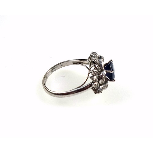 169 - White metal ring set sapphire and diamonds in a foliate design, size M 1/2, 3.6 grams, boxed (2)