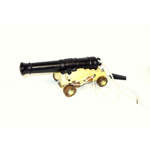 195 - Model of an iron cannon on a painted carriage, L.40cm; another iron cannon on an iron carriage, L.41... 