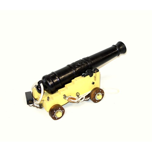 195 - Model of an iron cannon on a painted carriage, L.40cm; another iron cannon on an iron carriage, L.41... 