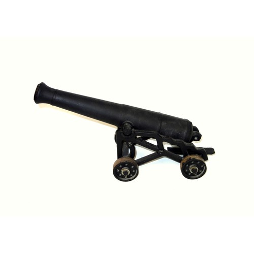 195 - Model of an iron cannon on a painted carriage, L.40cm; another iron cannon on an iron carriage, L.41... 