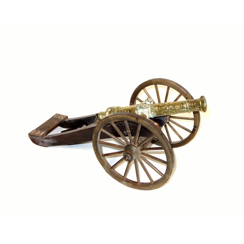 196 - Model of a brass 1647 cannon on a stained wood carriage with metal bound wheels, L.44cm, length of b... 