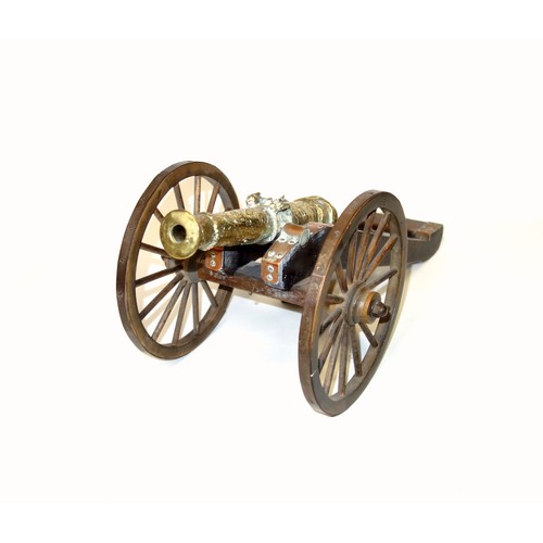 196 - Model of a brass 1647 cannon on a stained wood carriage with metal bound wheels, L.44cm, length of b... 