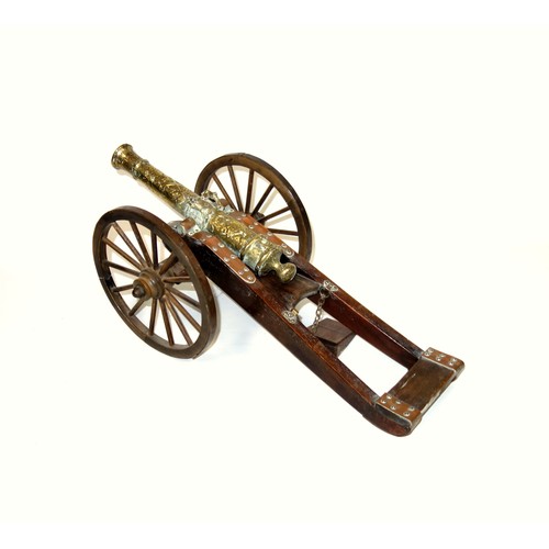 196 - Model of a brass 1647 cannon on a stained wood carriage with metal bound wheels, L.44cm, length of b... 