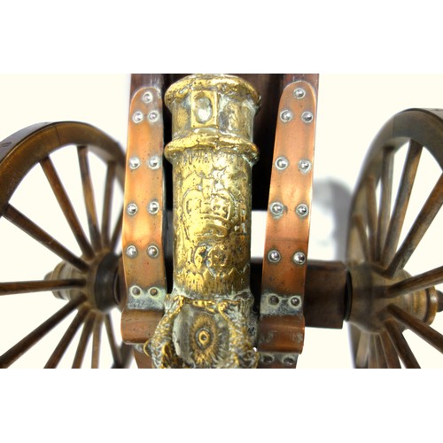 196 - Model of a brass 1647 cannon on a stained wood carriage with metal bound wheels, L.44cm, length of b... 