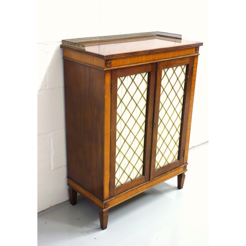 218 - Regency style mahogany and satinwood cabinet with 2 brass lattice and pleated fabric panelled doors,... 