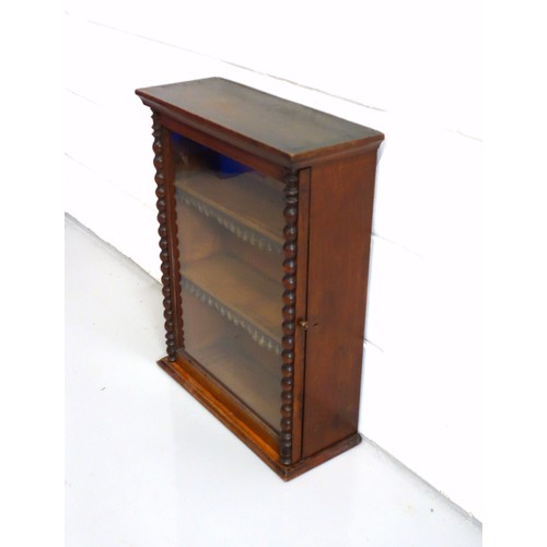 224 - Edwardian mahogany cabinet with a glazed panelled door flanked by bobbin turned pilasters, on a plin... 