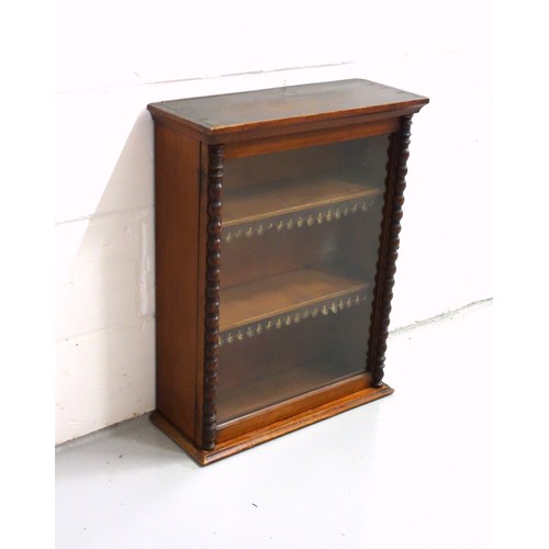 224 - Edwardian mahogany cabinet with a glazed panelled door flanked by bobbin turned pilasters, on a plin... 