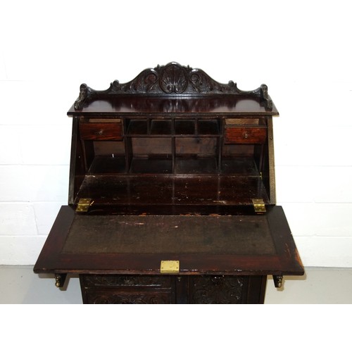 229 - Victorian carved oak bureau with a fall front and 4 drawers and a panelled door below, 125 x 91 x 50... 