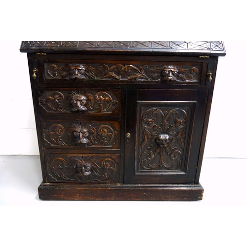 229 - Victorian carved oak bureau with a fall front and 4 drawers and a panelled door below, 125 x 91 x 50... 